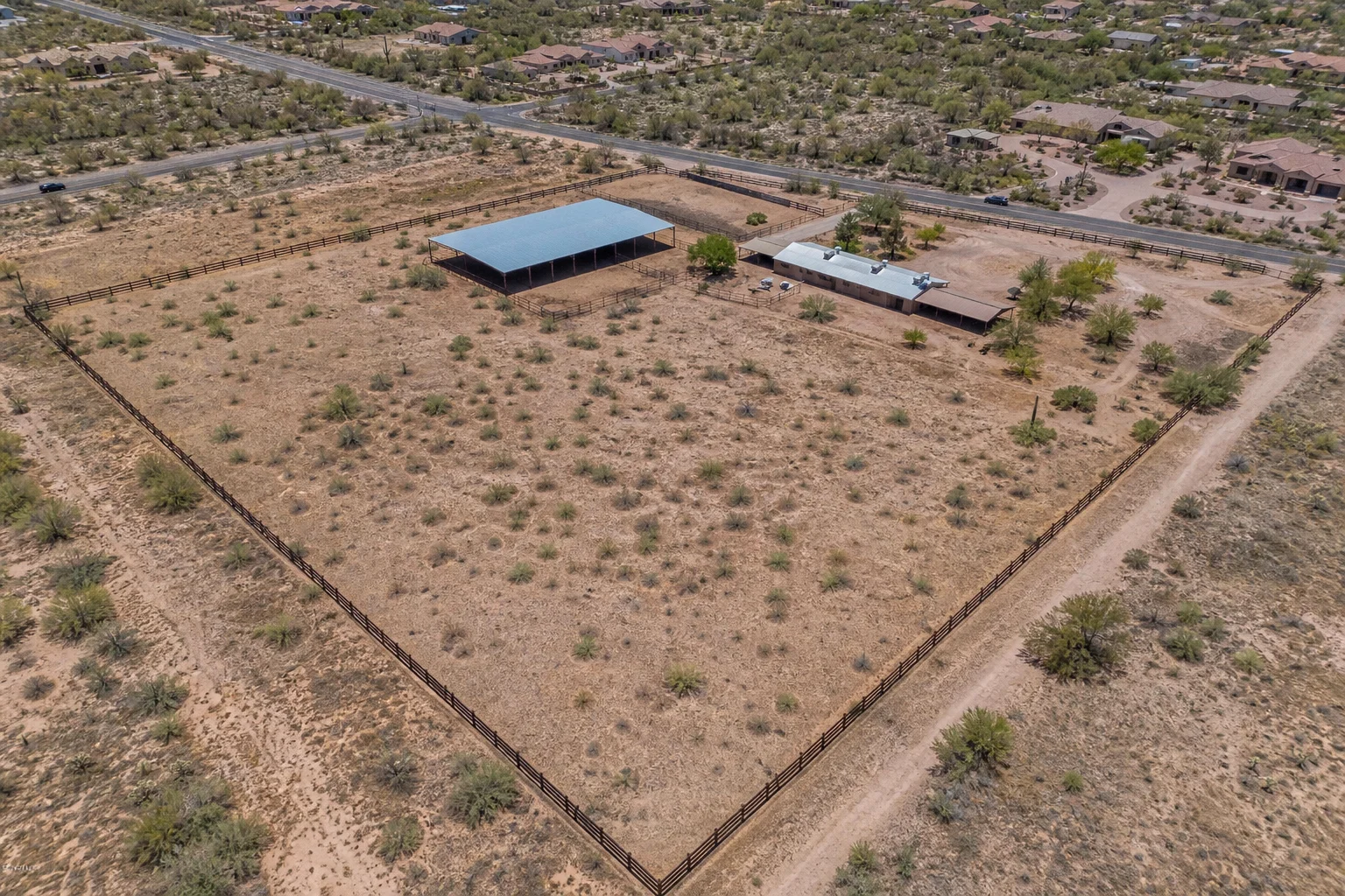 Aerial view of fenced horse property acreage with barn structures in San Tan Valley Arizona