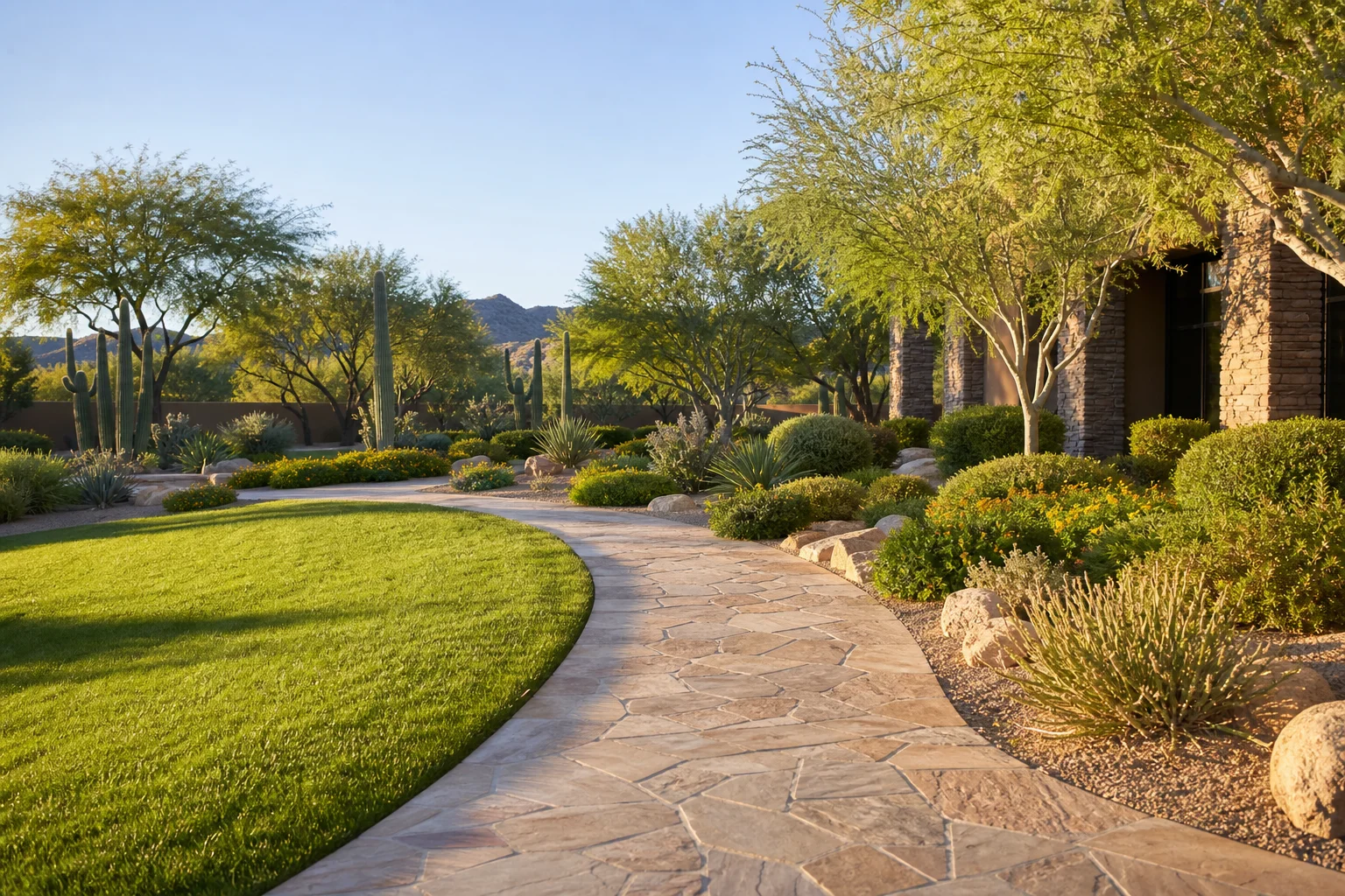 Arizona commercial property grounds crew performing scheduled landscape maintenance on irrigated turf at a commercial real estate property in the Valley