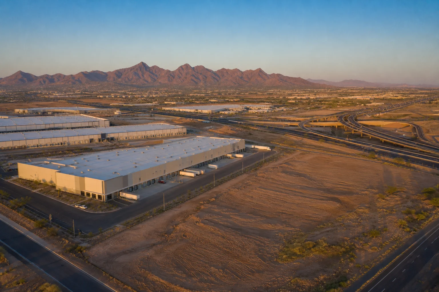 Aerial view of industrial land and warehouse development corridor in Maricopa County Arizona with freeway access
