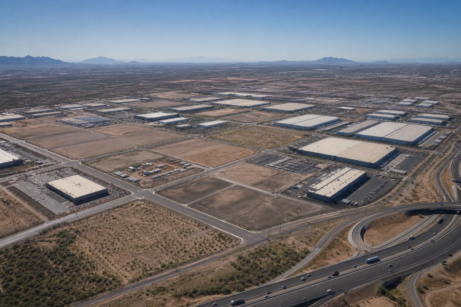 Aerial view of industrial land parcels and warehouse development sites in Maricopa County Arizona showing freeway access and site layout