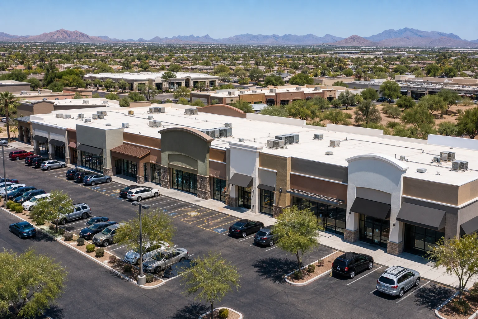 Aerial view of a Phoenix-area commercial building next to a vacant land parcel, representing an inherited property valuation