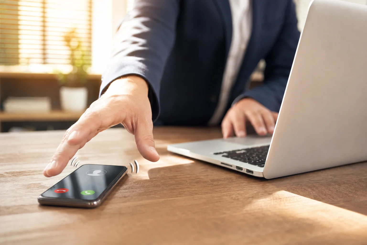 Insurance agent reviewing a lead notification alert on a laptop in a bright office
