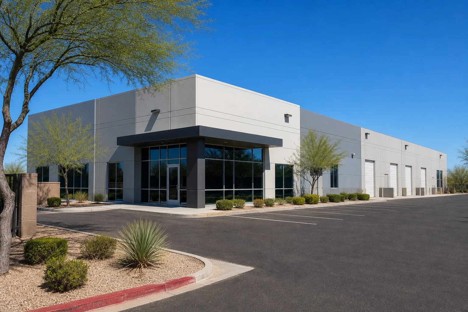 Exterior of a Phoenix industrial building with a for lease sign and clear blue sky