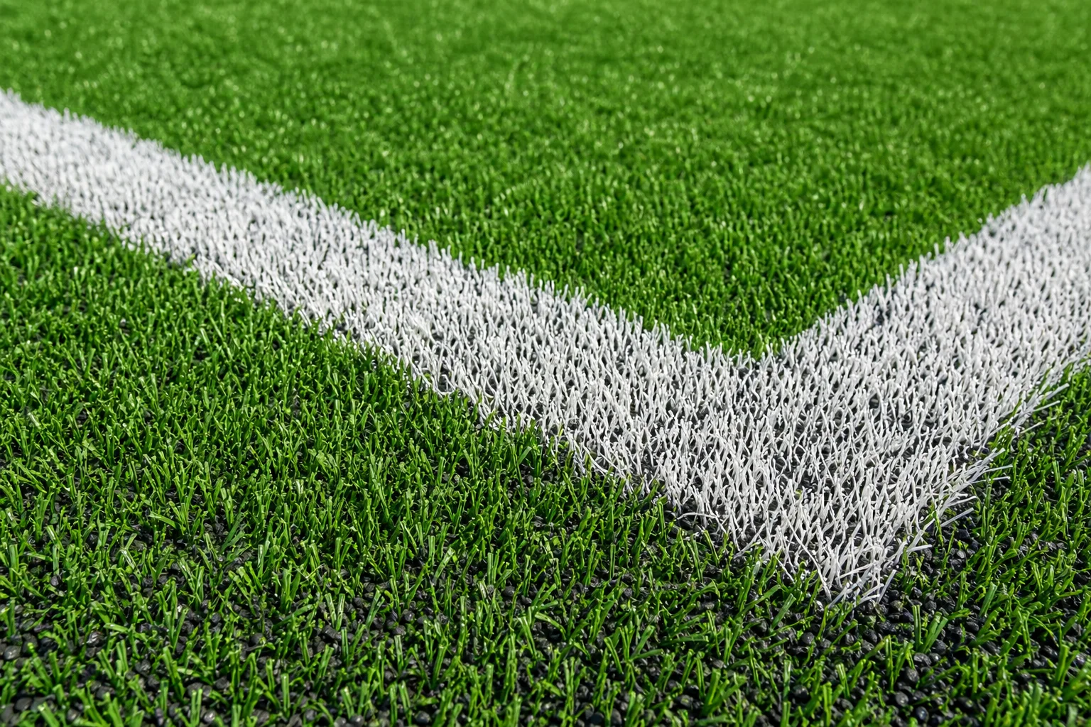 Vibrant synthetic turf athletic field with multi-sport line markings at a commercial park facility