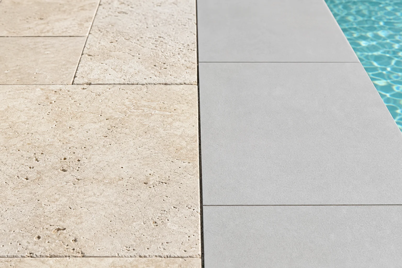 Travertine vs. porcelain pavers comparison on a sunlit Arizona commercial pool deck