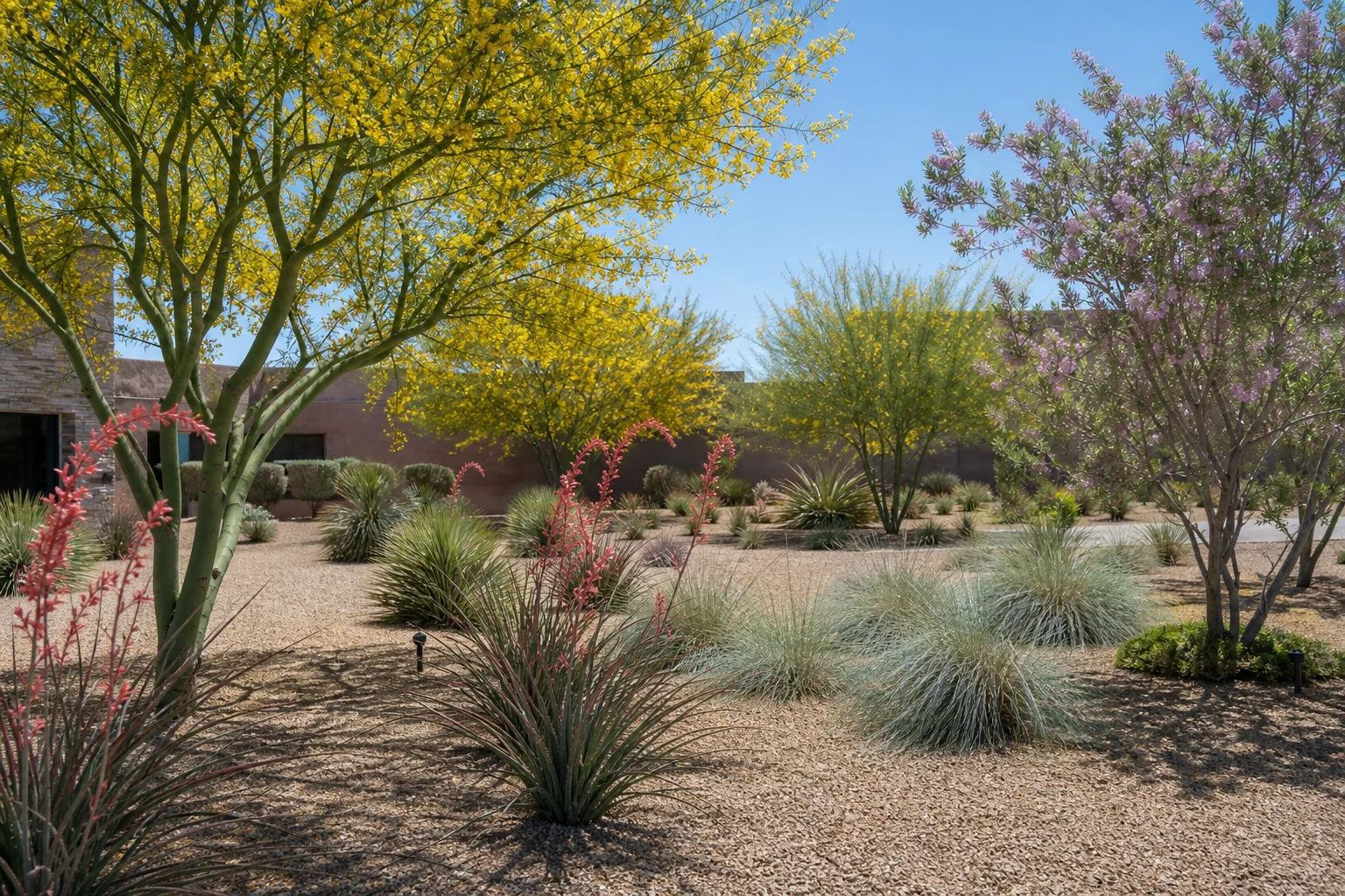 Professional landscaping crew maintaining native desert plants at an Arizona commercial property in summer heat